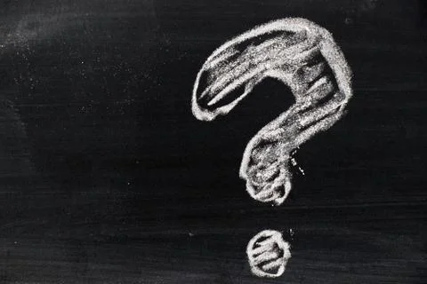 Chalk hand drawing as question mark shape on black board background Stock Photos