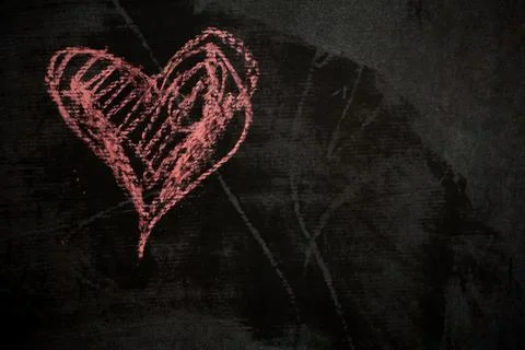 Chalk a heart on a dark surface for digital Valentines Day content. Stock Photos
