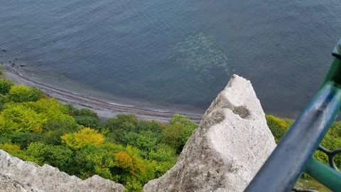 Chalk Pinnacle and Forested Shore Below a Clifftop Railing 動画素材 346411550