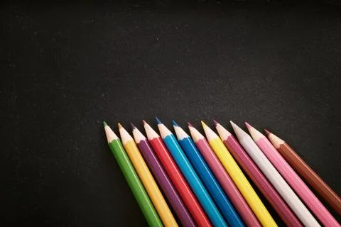 Chalkboard and crayons Stock Photos