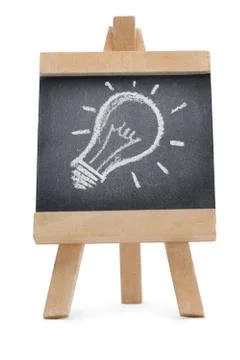 Chalkboard with a drawing of a light-bulb on it Stock Illustration