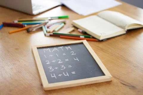 Chalkboard, math or notebook in homeschool study at house in covid lockdown Stock Photos