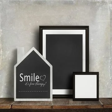 Chalkboard with quote and frames on table Stock Photos