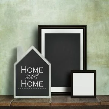 Chalkboard with quote and frames on table Stock Photos