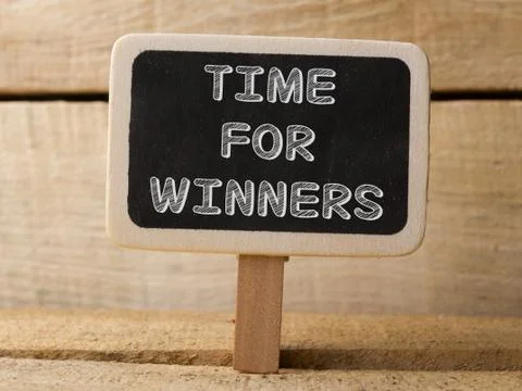 Chalkboard on wooden background with Time For Winners words 库存照片