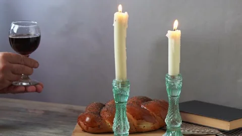 Challah bread, shabbat wine and candles on wooden table. Stock Footage 159446568