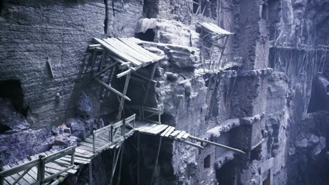 Challenging bridge with trembling planks over vertical abyss of mist Stock Footage 329942881