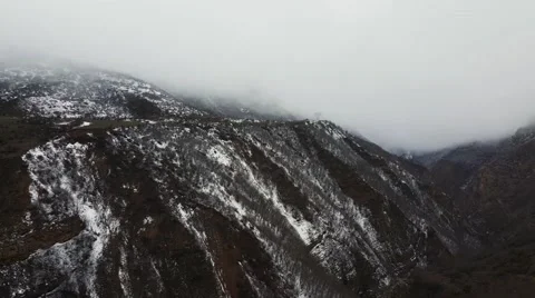 CHALUS, IRAN: A pan right to left of a snowy and foggy beautiful mountain Stock Footage 58952551