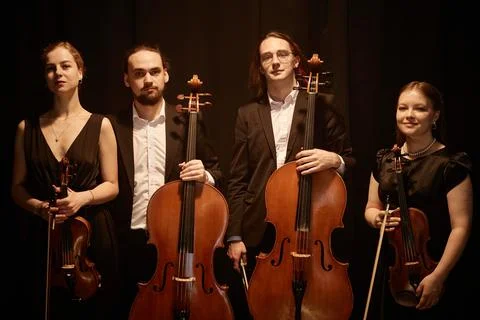 Chamber Quartet Posing with Instruments on Black Background Stock Photos