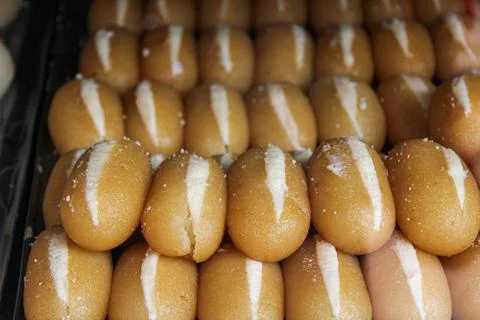 "chamcham" a kind of sweets placed on tray for sale in a shop Stock Photos
