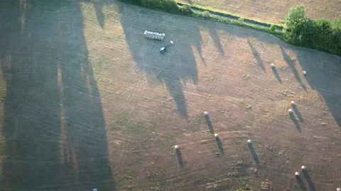 Chamfered field and haystacks after harvesting grain crops at sunset Stock Footage 199220465