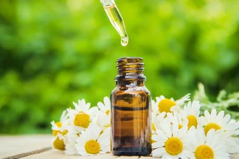 Chamomile extract in a small bottle. Selective focus. Stock Photos