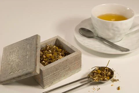 Chamomile tea with herb in a stone box 写真素材