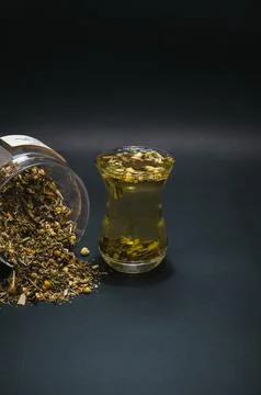 Chamomile tea scatter on black background Stock Photos