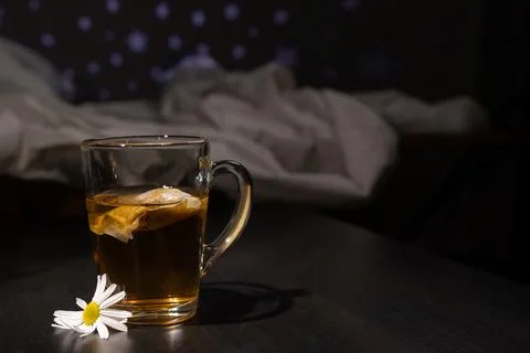 Chamomile Tea Sits Beside a Bed Welcoming a Peaceful Night of Sleep and Comfort Stock Photos