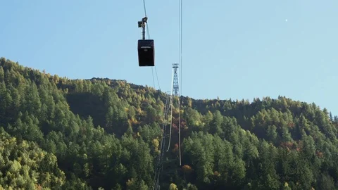 Chamonix Cable Car Hangs from Steel Cables Above Autumn Forest Stock Footage 82637166