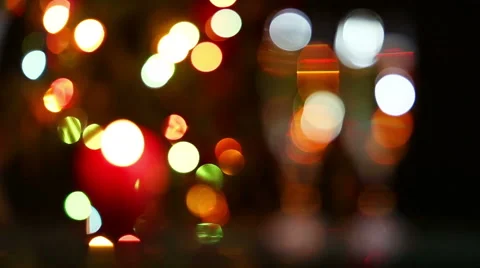 Champagne and candle against christmas lights Stock Footage