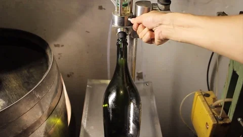Champagne bottle being filled Stock Footage 77044652