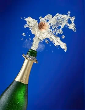 Champagne bottle opening with splash of bubbles and liquid Stock Photos