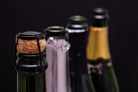 Champagne bottles in a row on the table close up Stock Photos