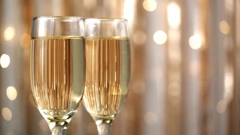Champagne bubbles in glasses on blurred background with flashing lights closeup. Stock Footage 263554146
