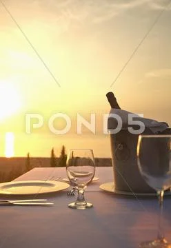 Champagne Bucket At Empty Table At Sunset