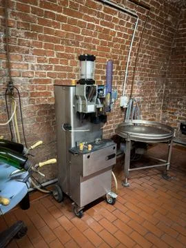 In a champagne cellar there is a machine for closing champagne bottles Stock Photos