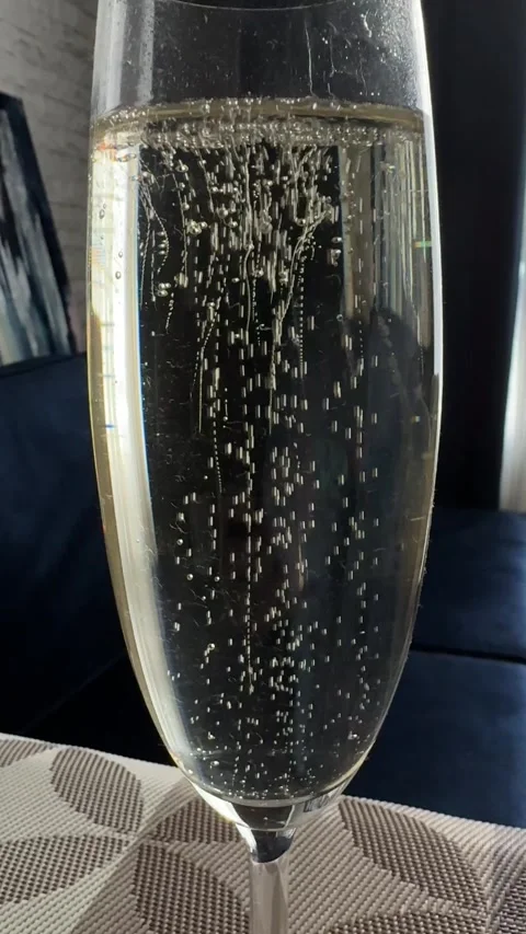Champagne flute with sparkling wine bubbles close up celebration drink Stock Footage 339480292