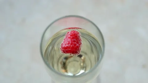 Champagne With Frozen Raspberry Stock Footage 131976613