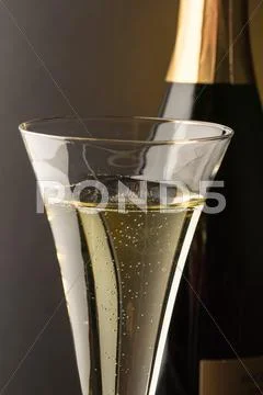 Champagne glass with champagne bottle Stock Photos
