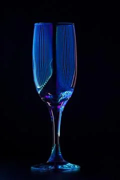 Champagne glass with reflection of colored rays of light Stock Photos