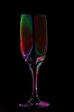 Champagne glass with reflection of colored rays of light Stock Photos