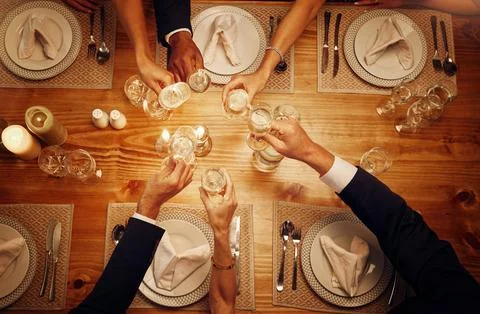 Champagne, glasses and cheers for celebration at a dinner for festive, new years Stock Photos
