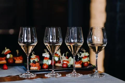 Champagne glasses on the background of snacks on the table Stock Photos