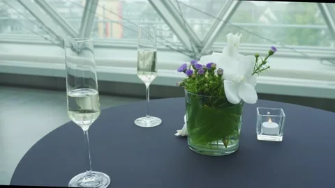 Champagne glasses, minimalistic table set and a caterer in the background Stock Footage 224315148