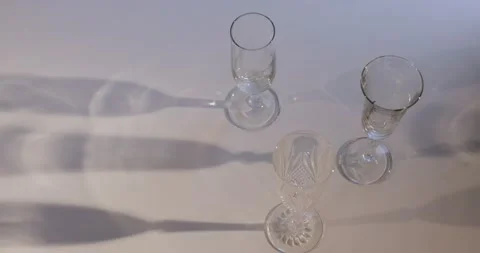 Champagne glasses projecting shadow on a table Stock Footage 142798079