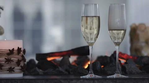 Champagne Pouring from the bottle. Two Flutes with Sparkling Wine over Holiday Stock Footage 59882889
