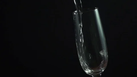 Champagne pouring into a glass on black background, slow motion hd video Stock Footage 71681853