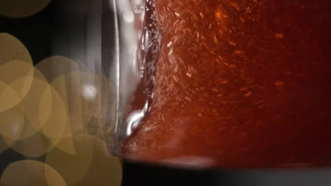 Champagne pouring in glass with lights bokeh background slow motion vertical Stock Footage 255144053