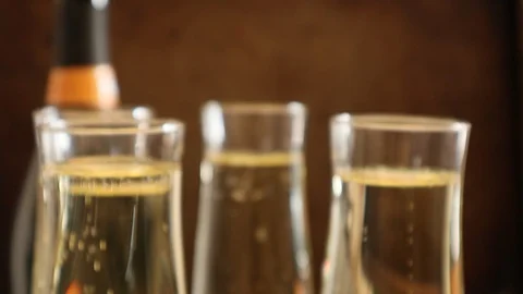 Champagne toast with bubbles moving in full glasses soft focus Vidéo 126088902