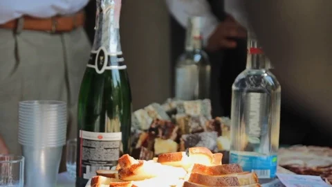 Champagne, vodka, sliced bread and a snack on the table. Stock Footage 79959834