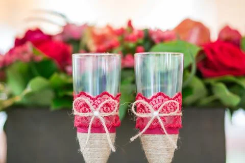 Champaign Glasses on the table with flowers on background 写真素材