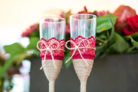 Champaign Glasses on the table with flowers on background 库存照片