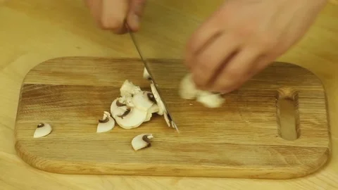 Champignon are cut with a sharp knife Stock-Footage 186664672