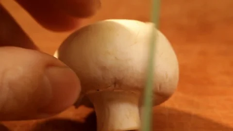 Champignon cutting with a green knife Stock Footage 84275094