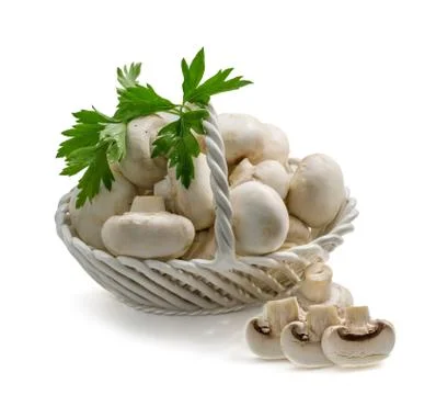 Champignons in a basket on a white background Stock Photos