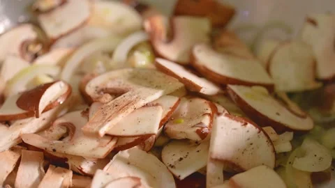 Champignons in a frying pan, close-up, slow motion. Stock Footage 225487670