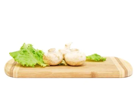 Champignons lying on cutting board Stock Photos