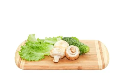Champignons lying on cutting board Stock Photos