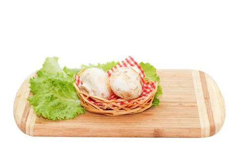 Champignons lying on cutting board Stock Photos